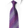 Knotted purple and magenta striped silk tie with crystal accents and silver sparkle against a white shirt.