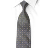 San-Dee rhinestone silk necktie DH216 — close-up of navy geometric lattice with crystal rhinestones and gold sparkles, showing gold monogram embroidery at blade tip