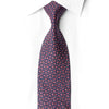San-Dee EH133 navy silk necktie laid diagonally on white, showing rose-pink interlocking geometric motifs and crystal rhinestone accents.