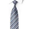 San-Dee silk necktie knotted against a white shirt, featuring silver scrollwork, blue diagonal stripes and crystal rhinestones.