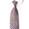 San-Dee purple geometric silk necktie knotted against a white shirt, showing lavender, black and golden-orange checks with sparkling rhinestones.