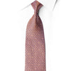 San-Dee orange and navy geometric rhinestone silk necktie rolled to show texture, crystal rhinestones and silver sparkle detail