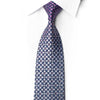 San-Dee RN658 silk tie knotted against a white shirt with navy, silver-gray and plum checkerboard squares and crystal accents.