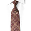 San-Dee burgundy silk rhinestone necktie with gold baroque scroll pattern worn knotted on white shirt — front view