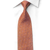 San-Dee amber gold geometric rhinestone silk necktie laid flat on white dress shirt, showing full length and intricate interlocking pattern