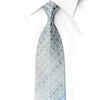 San-Dee men's silk rhinestone necktie in silver-blue ombre with emerald green crystal rhinestones and silver sparkles, rolled view showing interlocking circle jacquard pattern