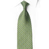 San-Dee sage green rhinestone silk necktie with floral link jacquard pattern and yellow-green crystal rhinestones, worn on white dress shirt – front view