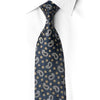 San-Dee navy silk necktie knotted against a white shirt, with crystal-outlined paisleys, gold-toned floral motifs, and silver sparkles.
