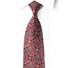 San-Dee crimson and black rhinestone silk tie knotted against a white shirt, showing flowing red waves, silver motifs and blue crystal accents.