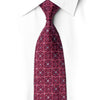 Burgundy floral silk necktie tied beneath a white collar with scattered crystal rhinestones